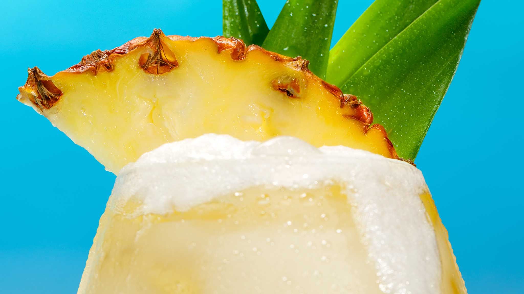 Malibu Piña Colada Cocktail against a blue background