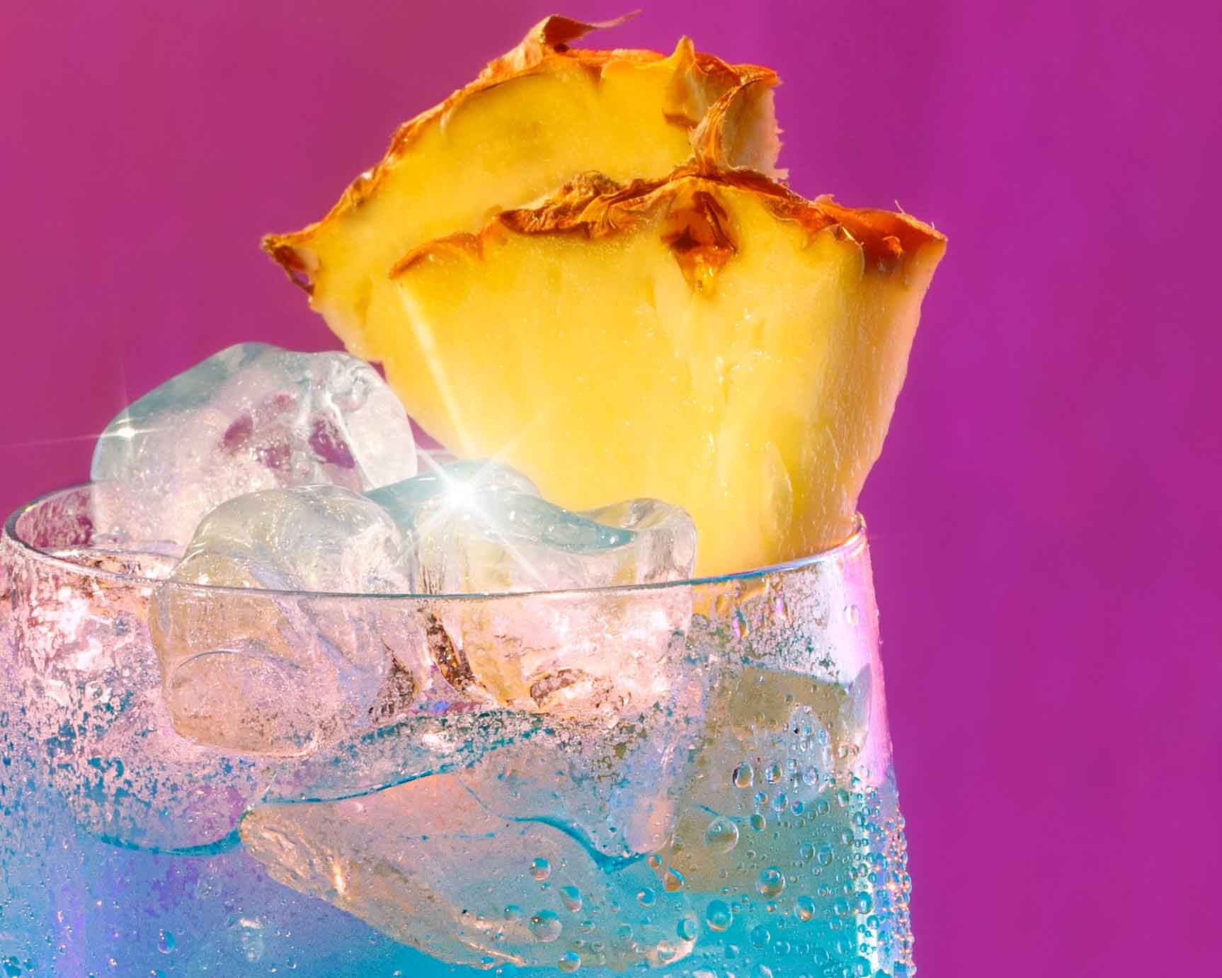 Malibu pineapple cocktail against a colourful gradient background