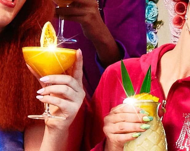 Two hands holding drinks