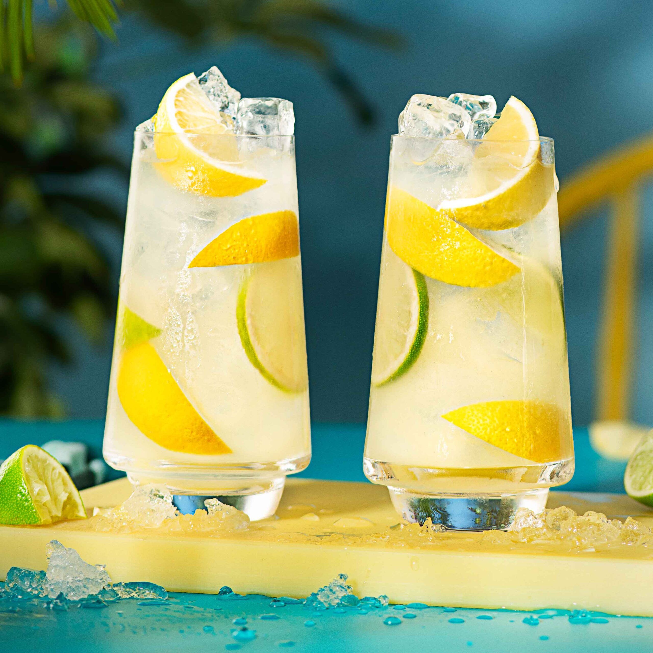 2 malibu lemonade cocktails on a yellow chopping board