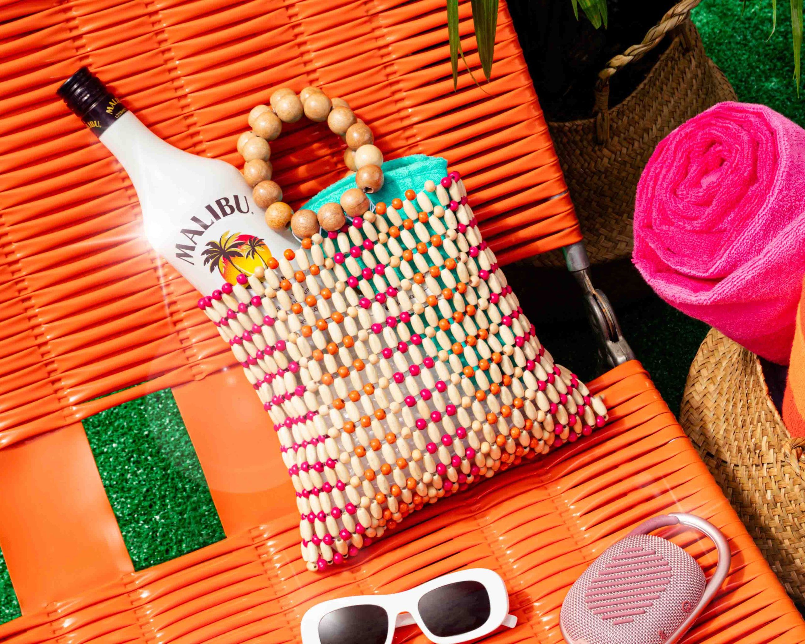 Malibu bottle in a tote bag on a sunbed