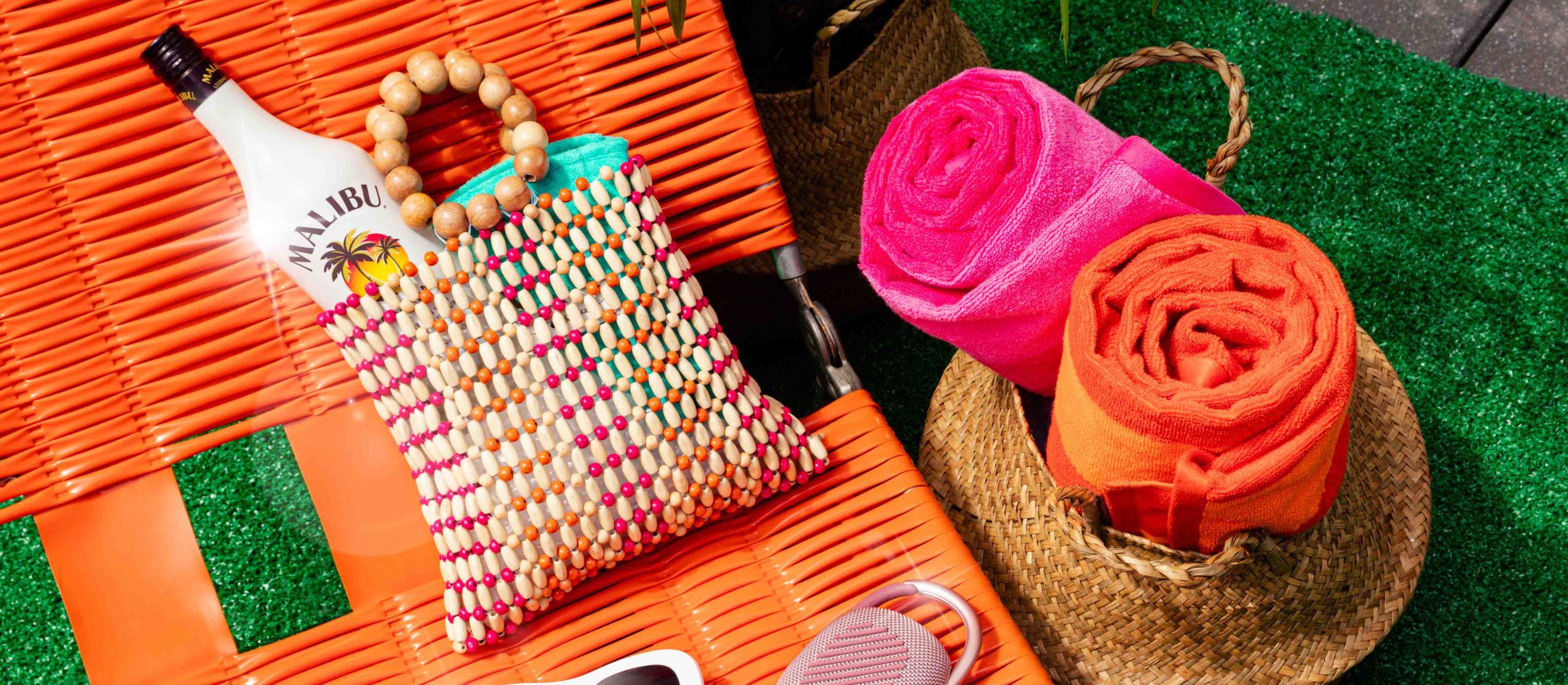 Malibu bottle in a tote bag on a sunbed
