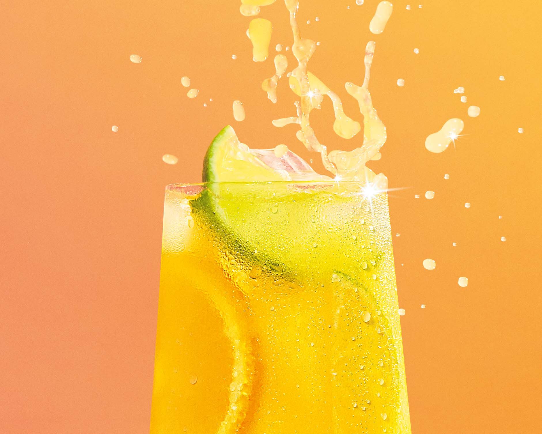 Close up of Orange drink with lime and orange garnishes