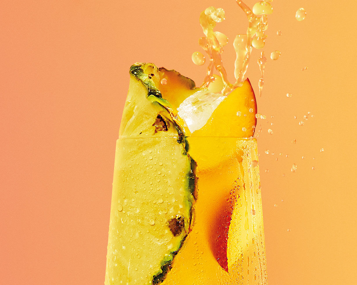 Close up a yellow malibu cocktail being splashed
