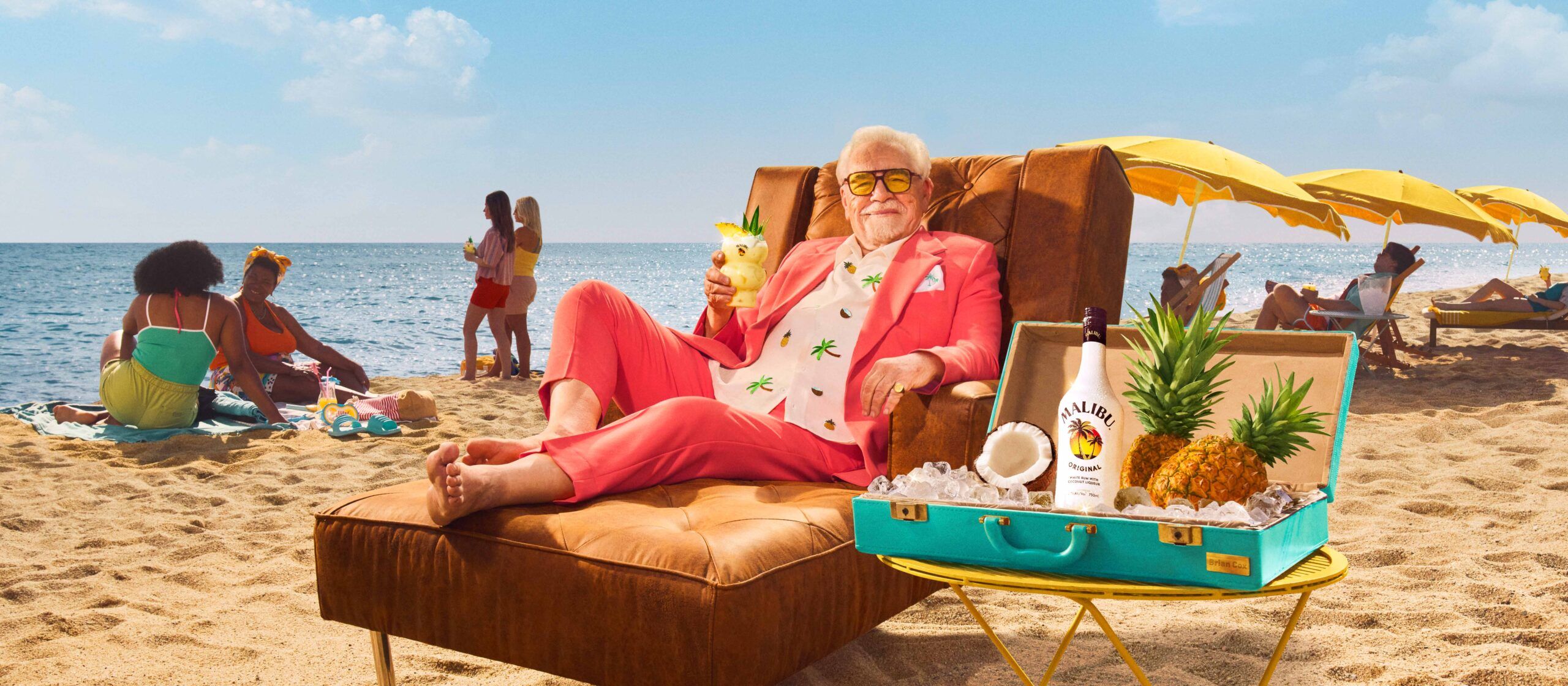 Brian Cox lounging on beach with pina colada