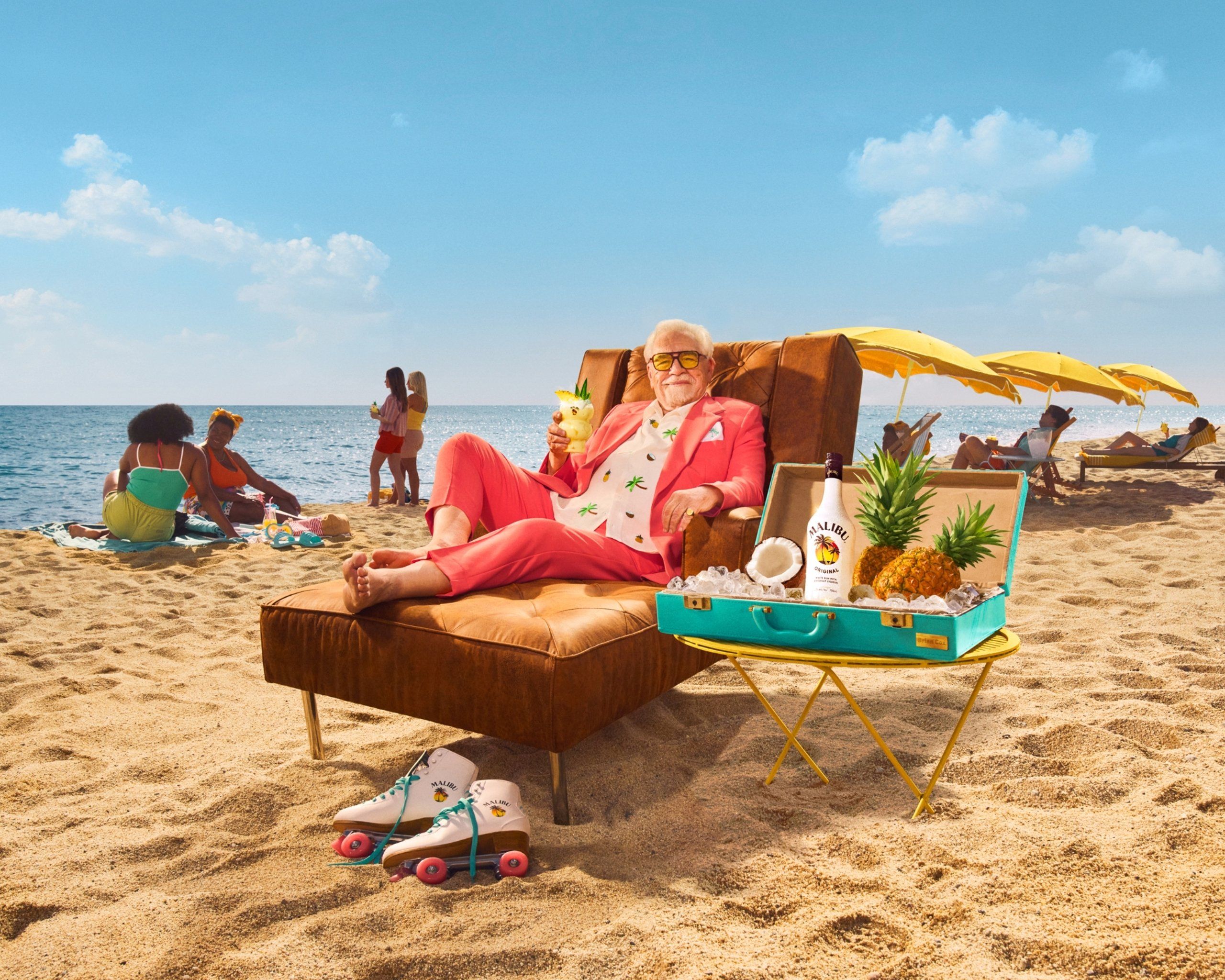Brian Cox drinking Pina colada in a lounger on the beach