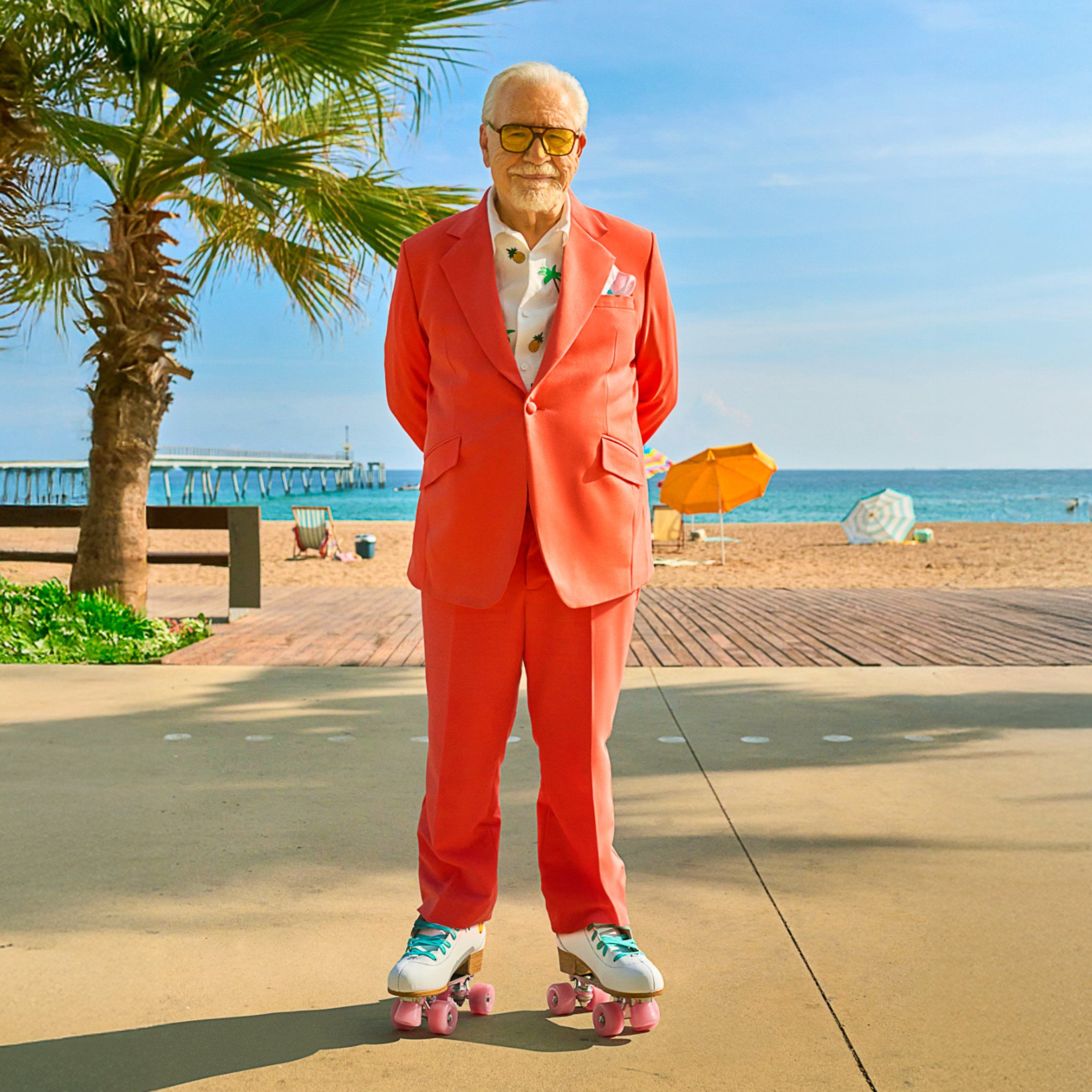 Brian Cox in rollerskates on beach