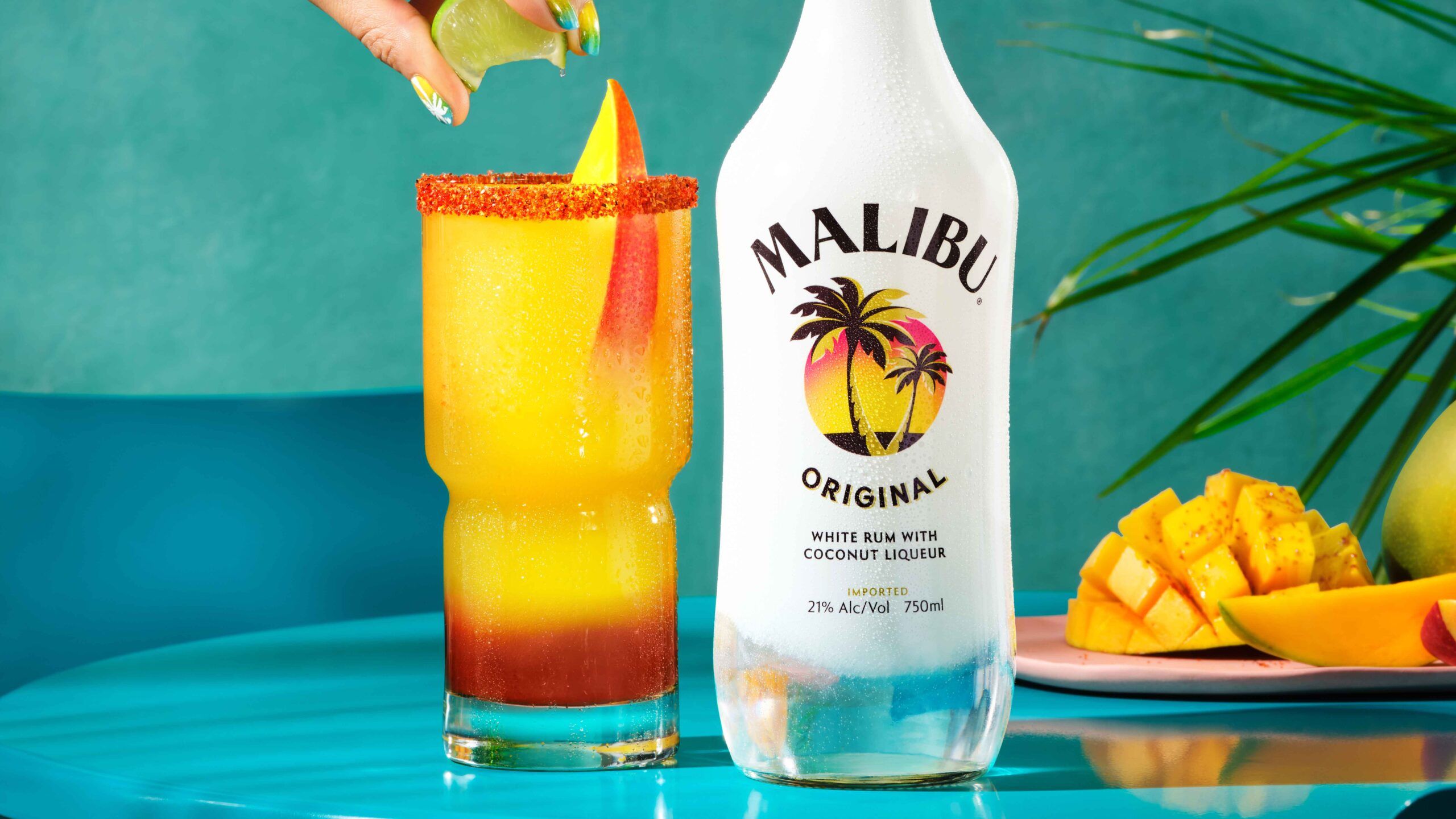 Mangonada cocktail next to Malibu Original Bottle