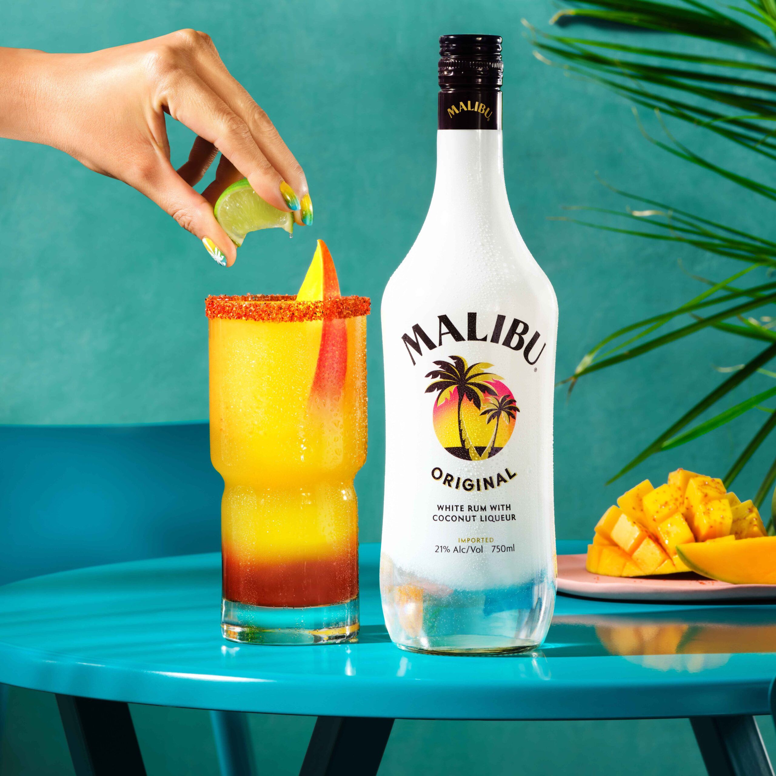 Mangonada cocktail next to Malibu Original Bottle