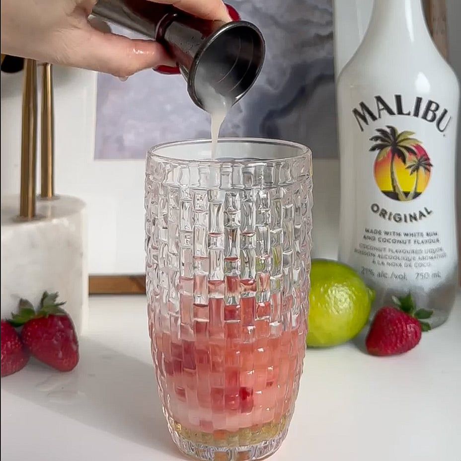 Ingredients being poured into a shaker.