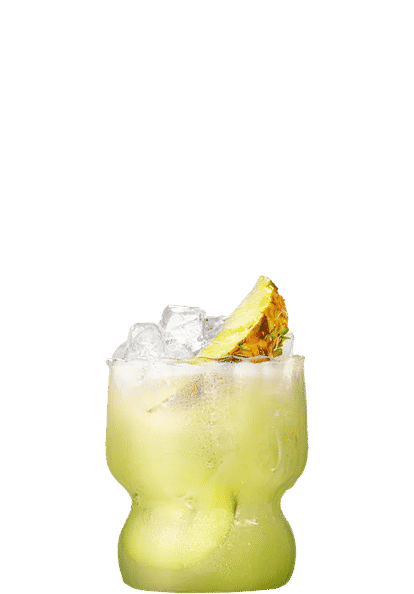 Malibu Kiwi Dream cocktail in a short curved glass with pale green drink, ice cubes, and pineapple slice garnish, condensation on the glass, isolated on a white background.