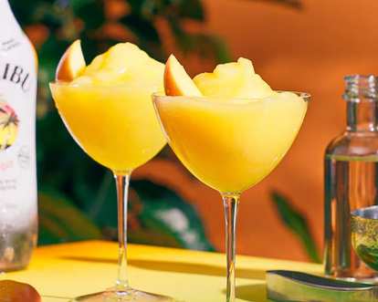 Two glasses of yellow Malibu Frozen Mango Daiquiri
