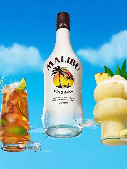 Malibu Original bottle centered between two tropical cocktails, one iced with lime splash, one creamy Piña Colada with pineapple garnish, bright blue sky and clouds creating fresh island vibe.