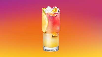 Malibu Passion Fruit Bay Breeze served over ice with passion fruit and pineapple slices for a vibrant, tropical refreshment.