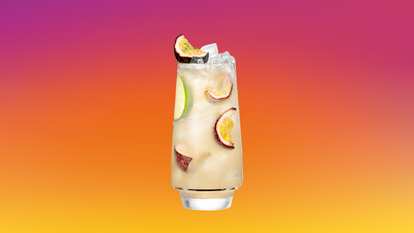 Malibu Passion Fruit Lemonade served over ice with passion fruit and lime slices for a crisp, tropical refreshment.