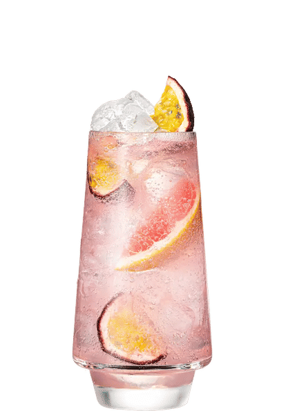 Malibu Passionfruit & Pink Grapefruit Soda cocktail in a tall glass with light pink sparkling drink, ice cubes, grapefruit slices, and halved passion fruit garnish, condensation on the glass, isolated on a white background.