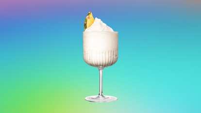 Malibu Piña Colada Slushy served blended with ice and topped with a pineapple slice for a creamy, tropical frozen cocktail.