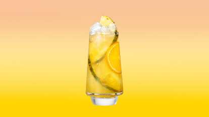 Malibu Pineapple & Orange Juice served over ice with orange and pineapple slices for a bright, smooth tropical refreshment.