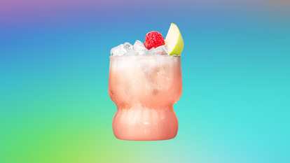 Malibu Rapple served over ice with raspberry and green apple garnish for a crisp, fruity tropical cocktail.