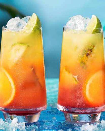 Two Malibu Sunrise Cocktails on tray with limes