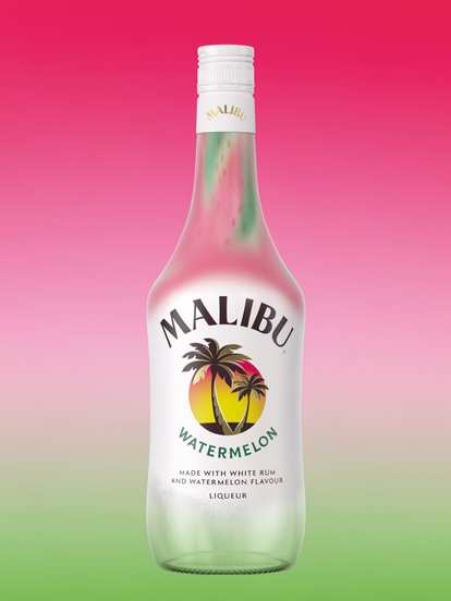 A Malibu Watermelon bottle displayed against a pink‑to‑green gradient background that mirrors watermelon colors. The white bottle features pink and green accents near the neck and the signature Malibu palm logo, evoking a fresh, tropical, summer vibe.