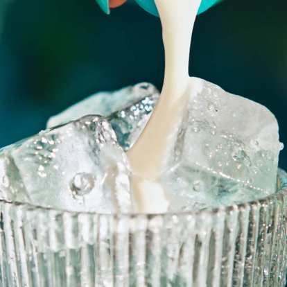 Close up of Malibu Pina Colada being poured into a glass with ice