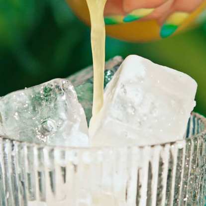 Close up of Malibu Pina Colada being poured into a glass with ice