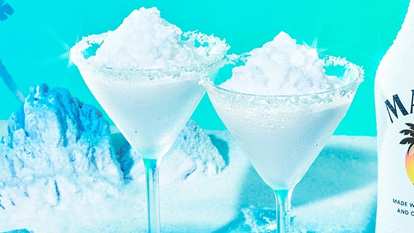 Two Malibu Snow Colada blended with coconut cream and ice for a smooth, frosty, winter‑bright tropical colada.