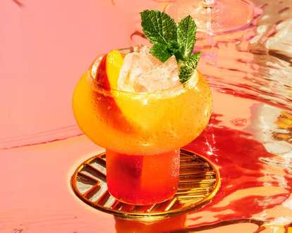 A yellow and red Malibu drink served as a cocktail on Thanksgiving