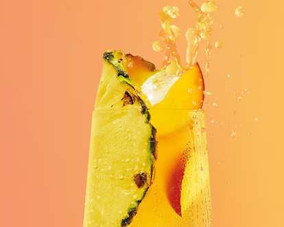 A yellow Malibu Drink with Pineapple and Peach