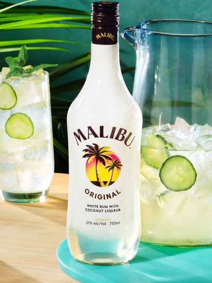 Malibu  El Caribeño made with Malibu  Original rum, cucumber slices, ice, and mint. Served in tall glasses beside a pitcher.
