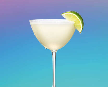 a martini glass of Malibu daiquiri decorated with lime